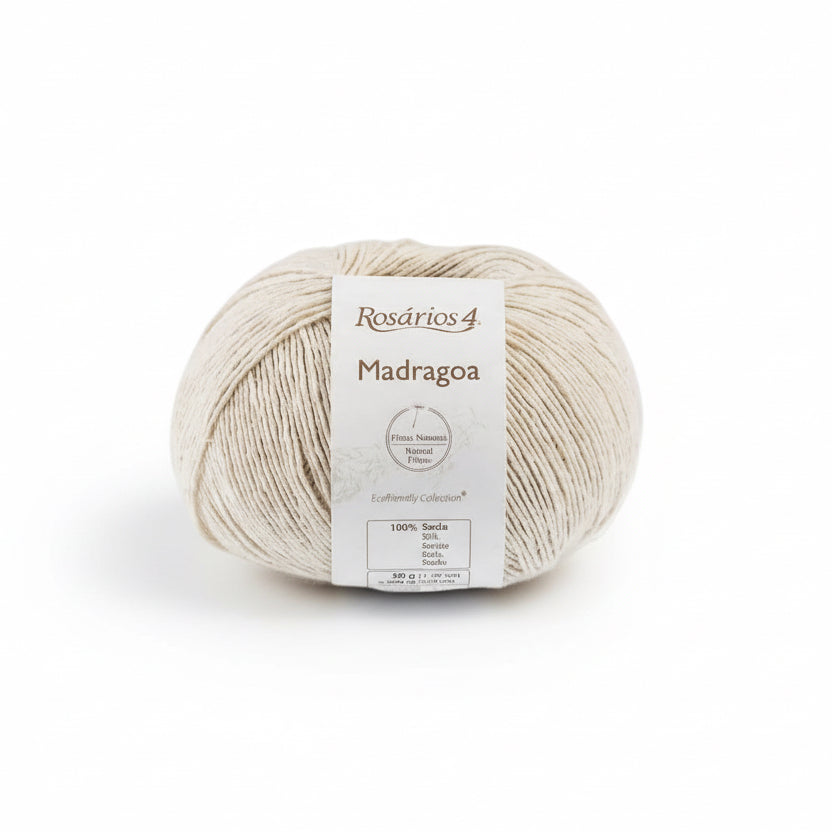 ecru Ball of Silk Yarn with a label with madragoa on a light gray background