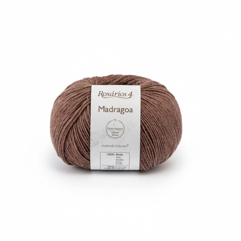 ecru Ball of Silk Yarn with a label with madragoa on a light gray background