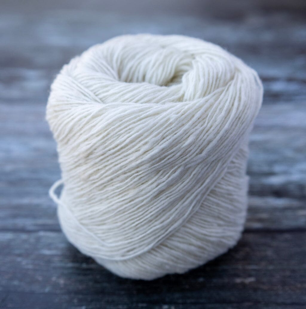 ball of natural coloured yarn on wooden surface