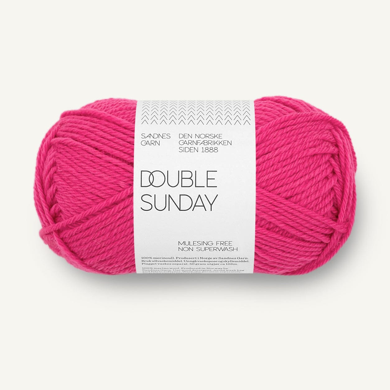 A skein of bright pink yarn with a white paper label reading 'DOUBLE SUNDAY' and 'SANDNES GARN', photographed on a clean off-white background.
