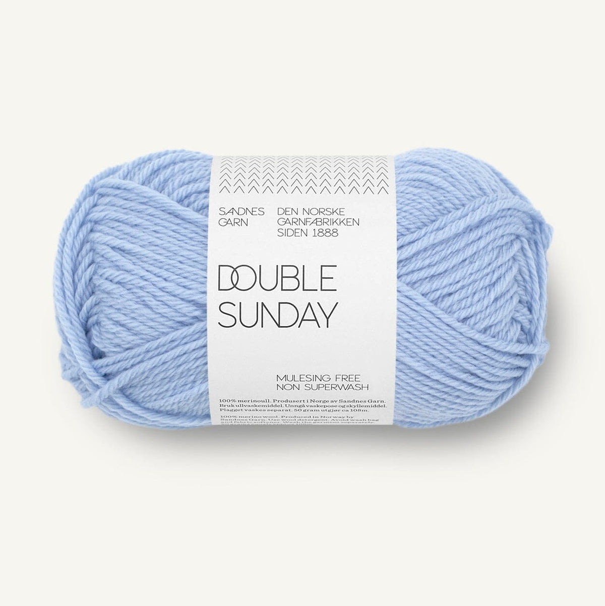 A single ball of light blue yarn with a white paper label reading 'DOUBLE SUNDAY' and 'SANDNES CARN', photographed on a clean off-white background.