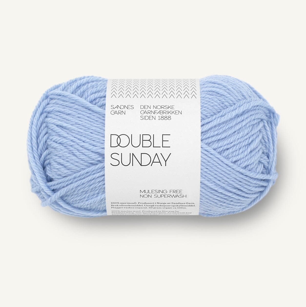 A single ball of light blue yarn with a white paper label reading 'DOUBLE SUNDAY' and 'SANDNES CARN', photographed on a clean off-white background.
