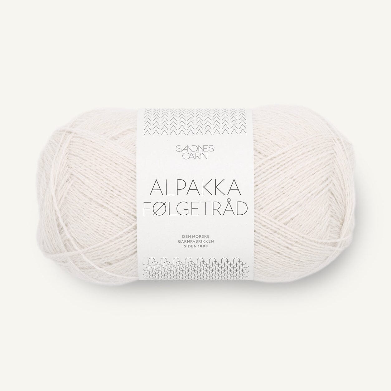 A skein of off-white alpaca wool yarn with a white paper label reading 'SANDNES GARN ALPAKKA FØLGETRÅD' on a light cream background.
