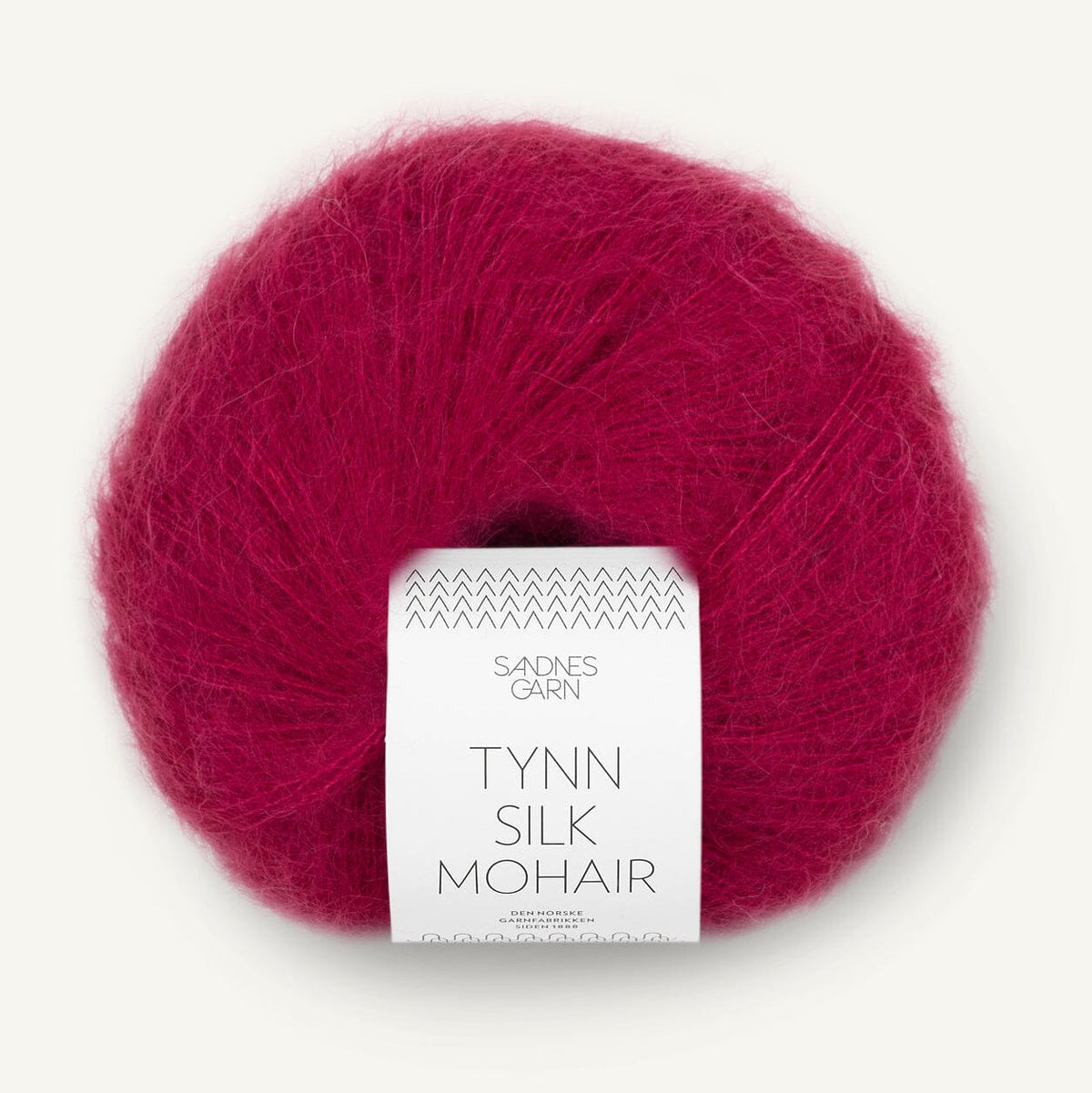Ball of red yarn with a label on a white background