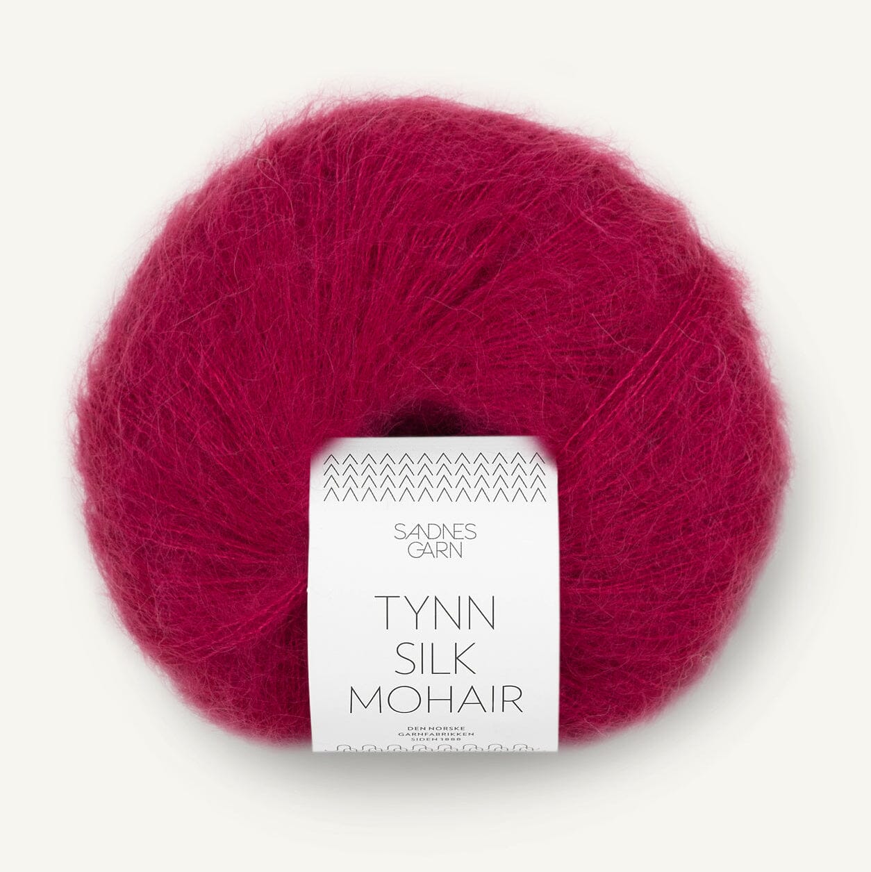 Ball of red yarn with a label on a white background