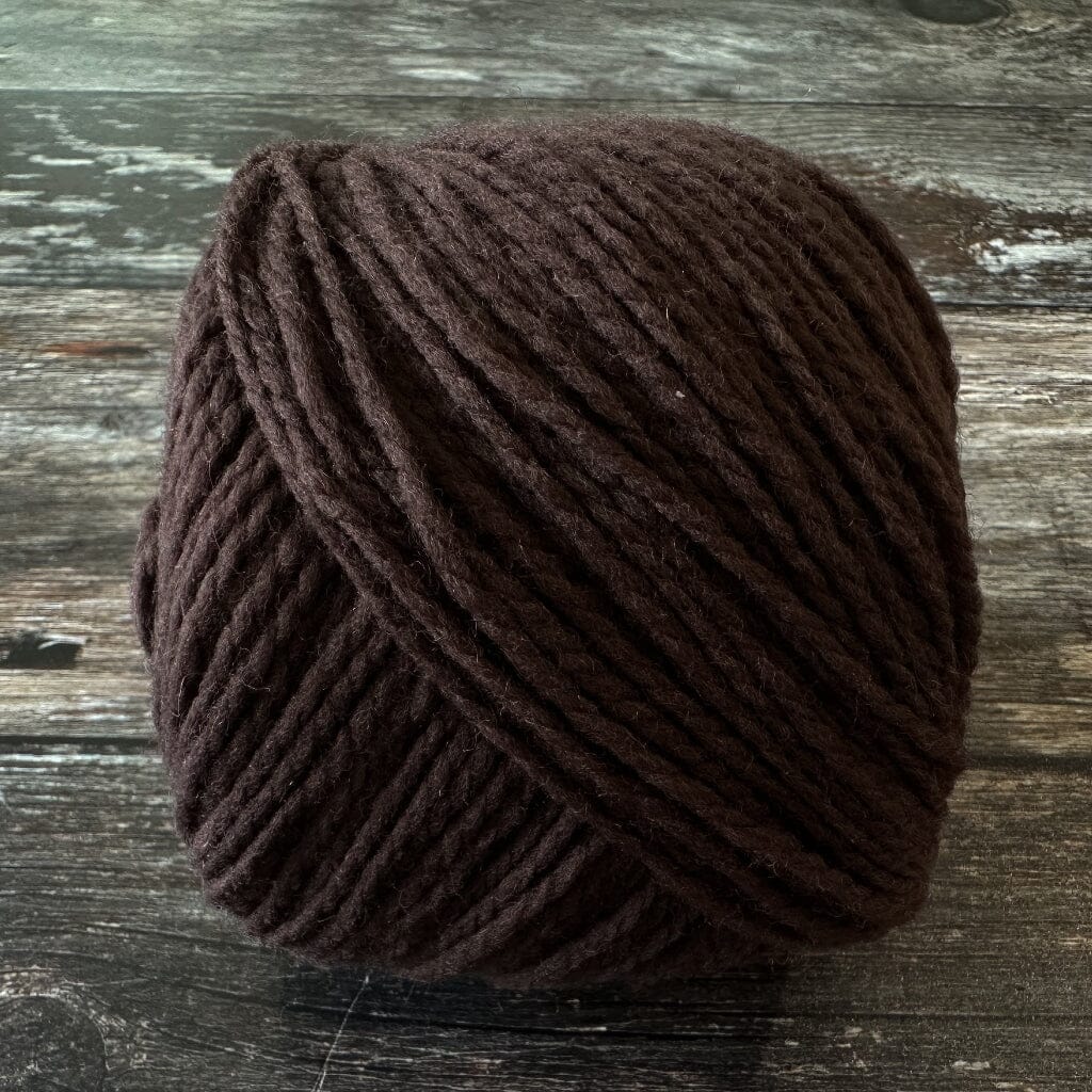 Brown yarn ball on a wooden surface