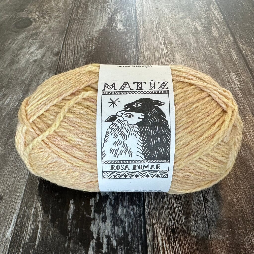 Ball of yarn with a label on a wooden surface