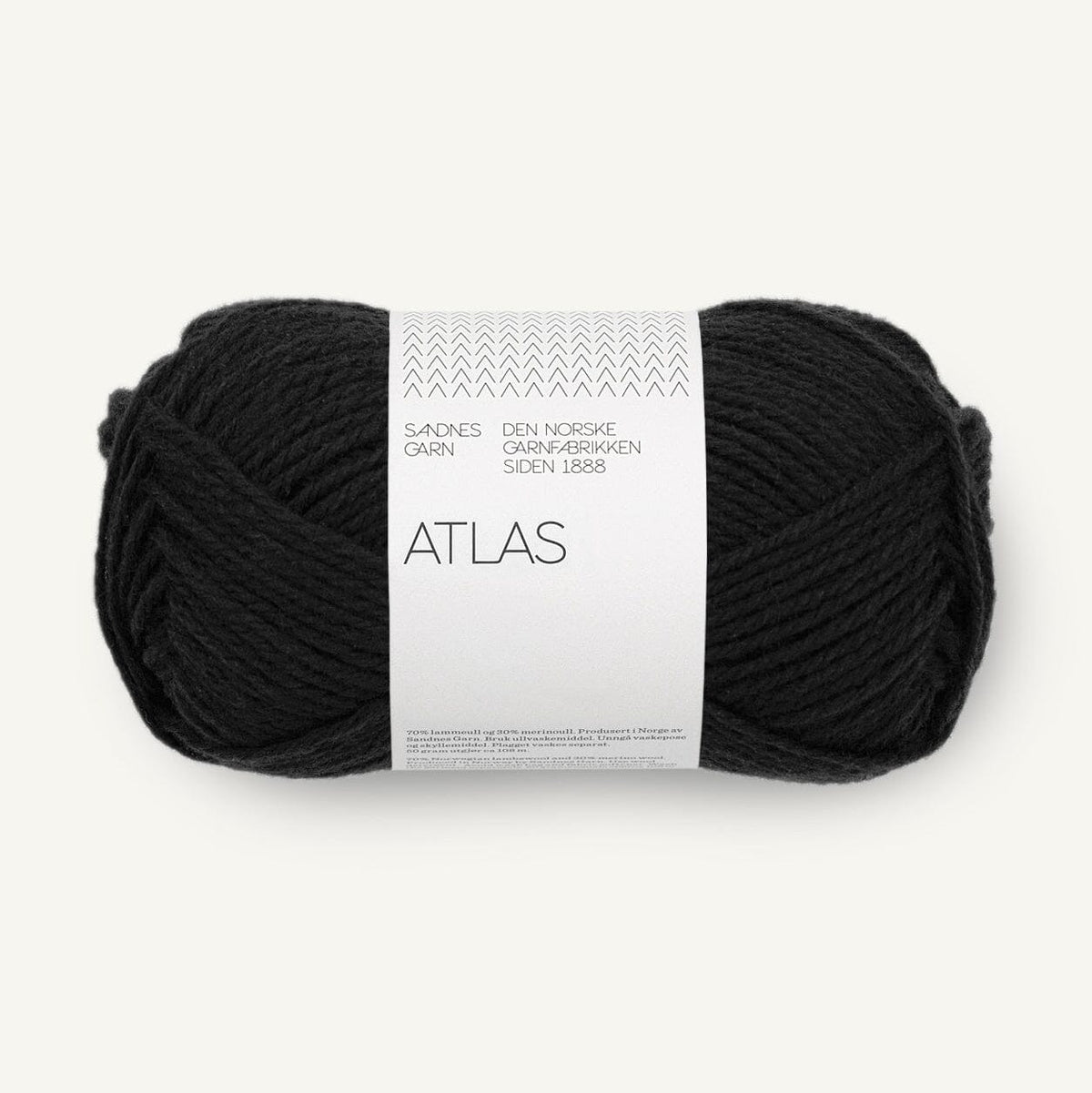 Black yarn ball with a white label on a white background
