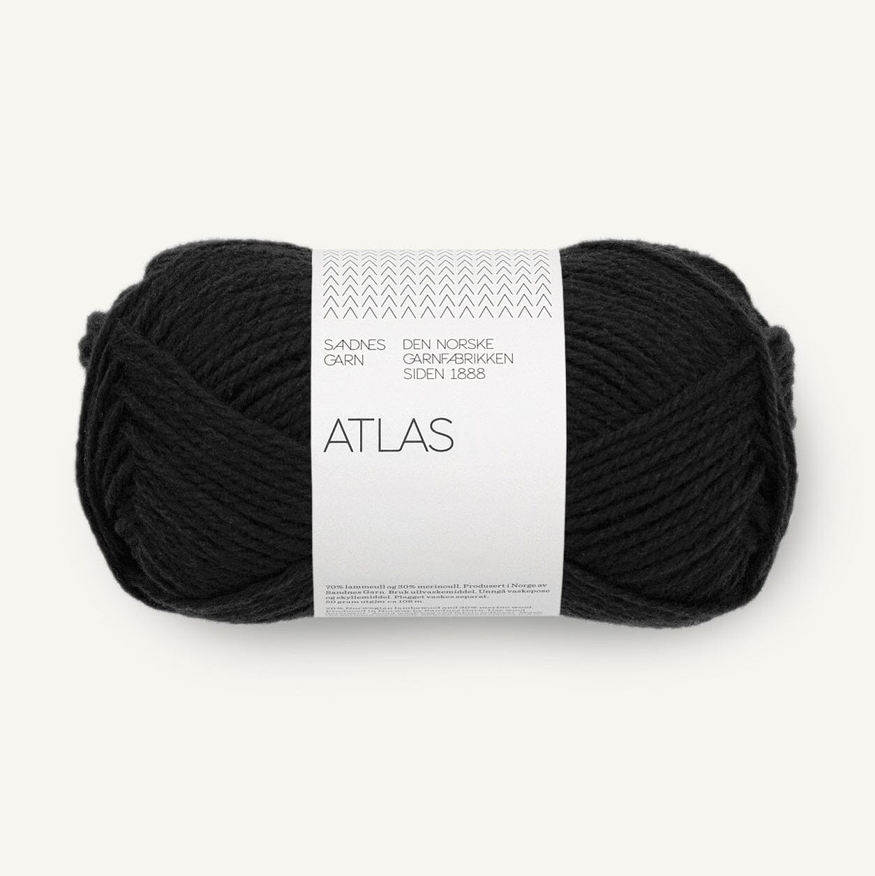 Black yarn ball with a white label on a white background