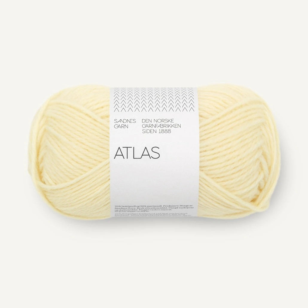 Ball of yellow yarn with a label on a white background