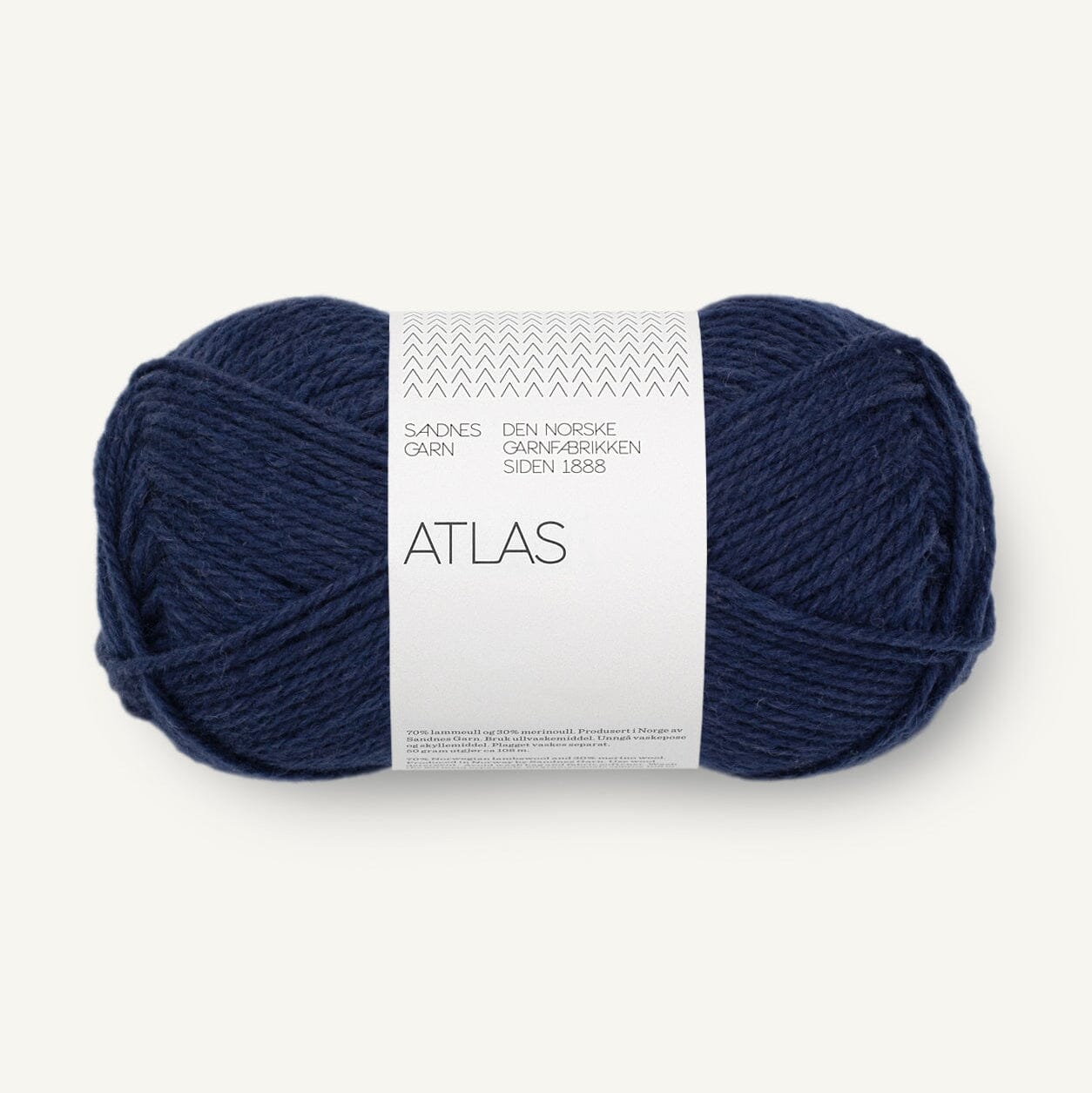 Navy blue skein of yarn with a white label on a light gray background