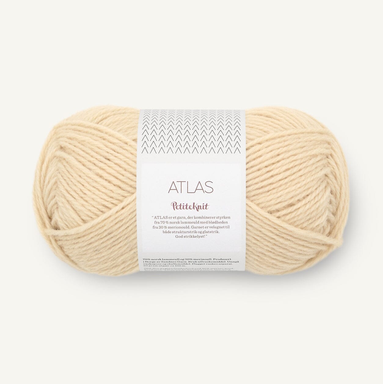 Ball of cream-colored yarn with a label on a white background