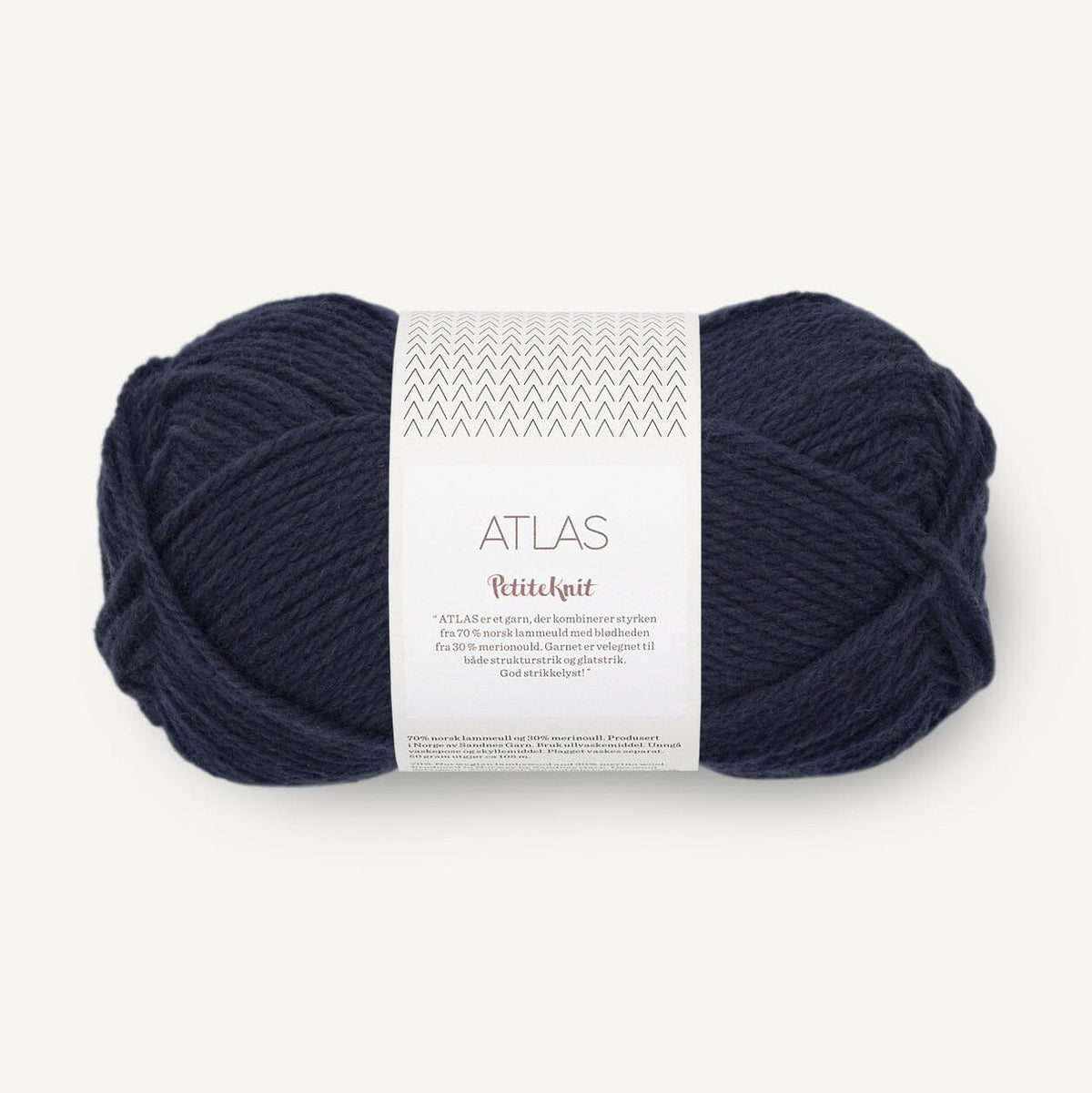 Navy blue skein of yarn with a label on a white background