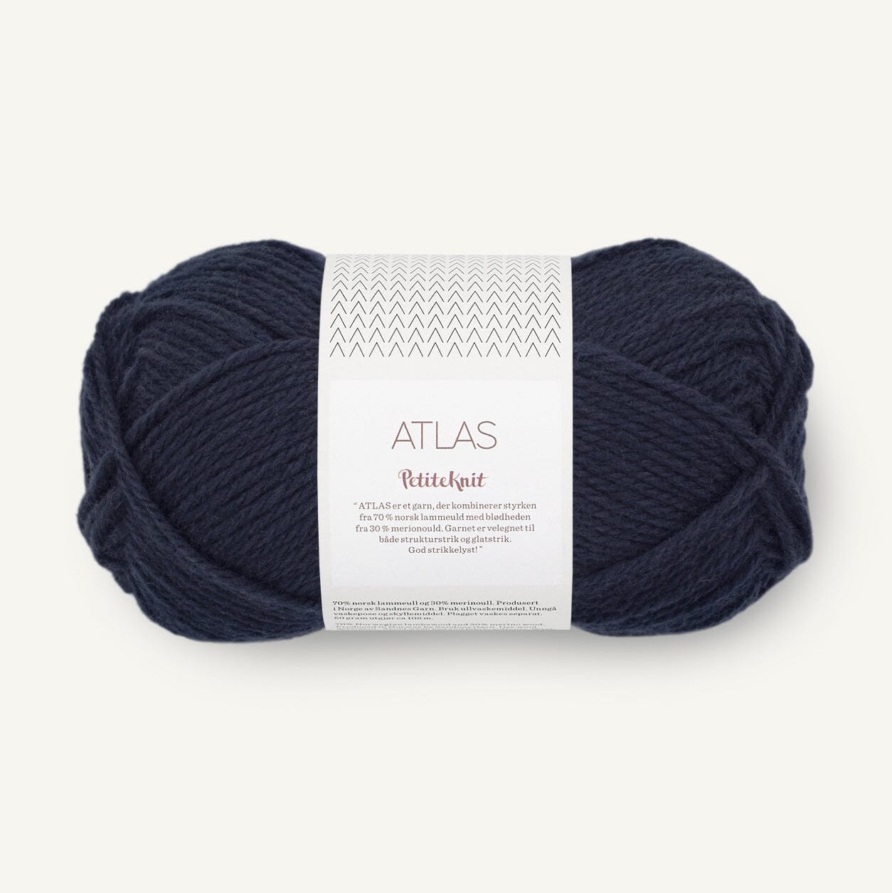 Navy blue skein of yarn with a label on a white background
