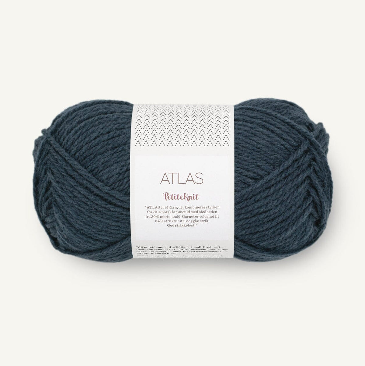 Ball of dark blue yarn with a label on a white background