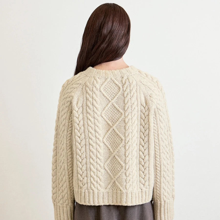 women standing to the  back wearing knit cable sweater