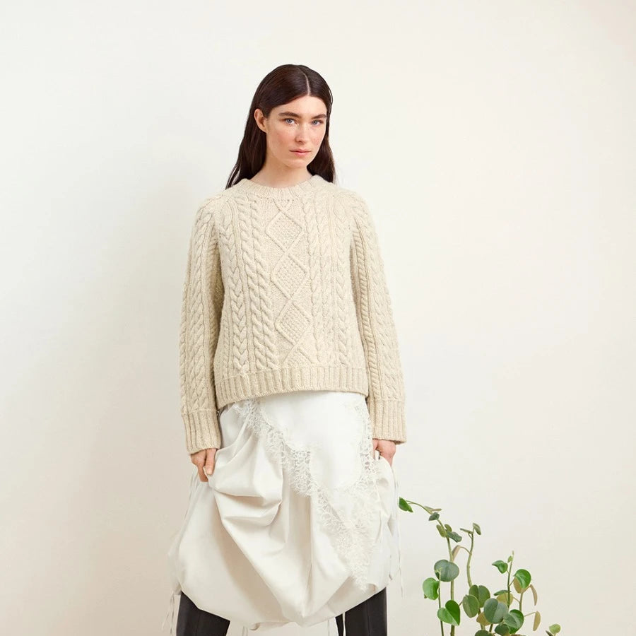 Women wearing knit cable sweater