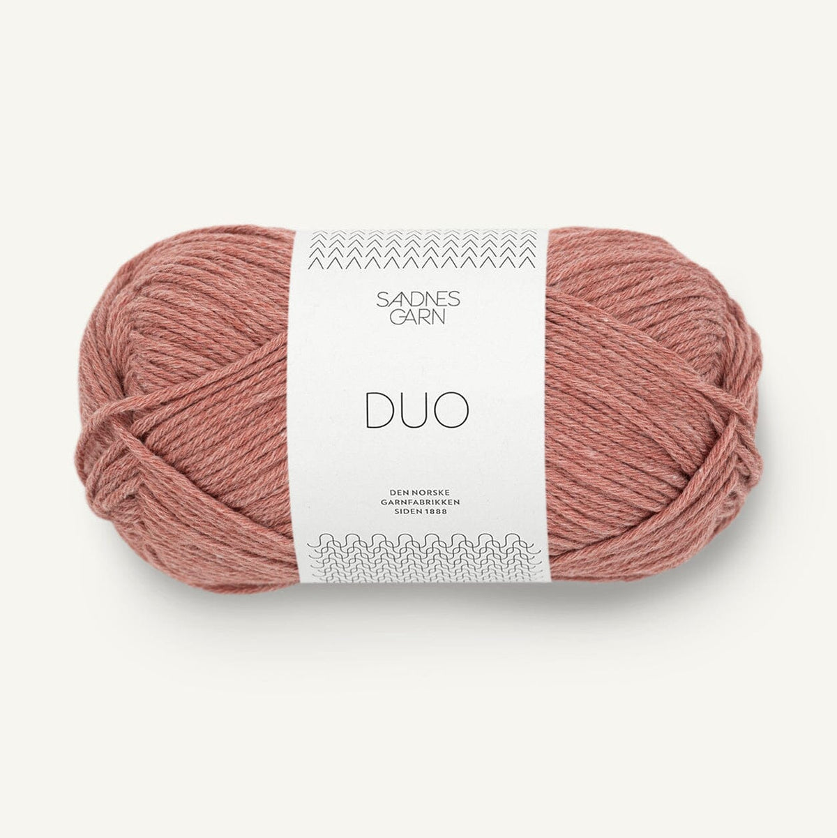 Ball of pink yarn with a white label on a light beige background