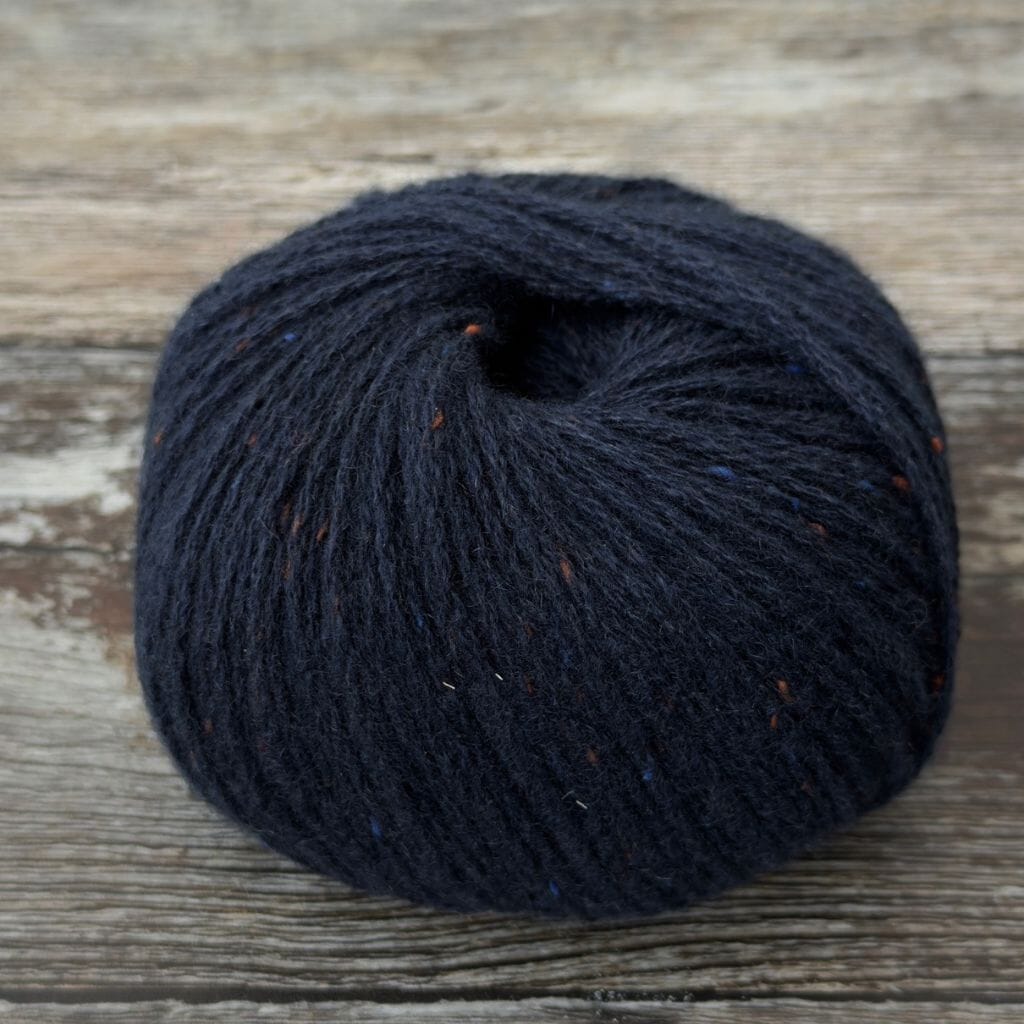 Dark blue skein of yarn on a wooden surface