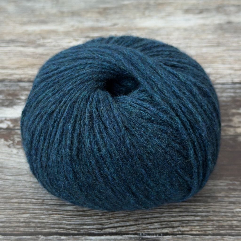 Blue skein of yarn on a wooden surface