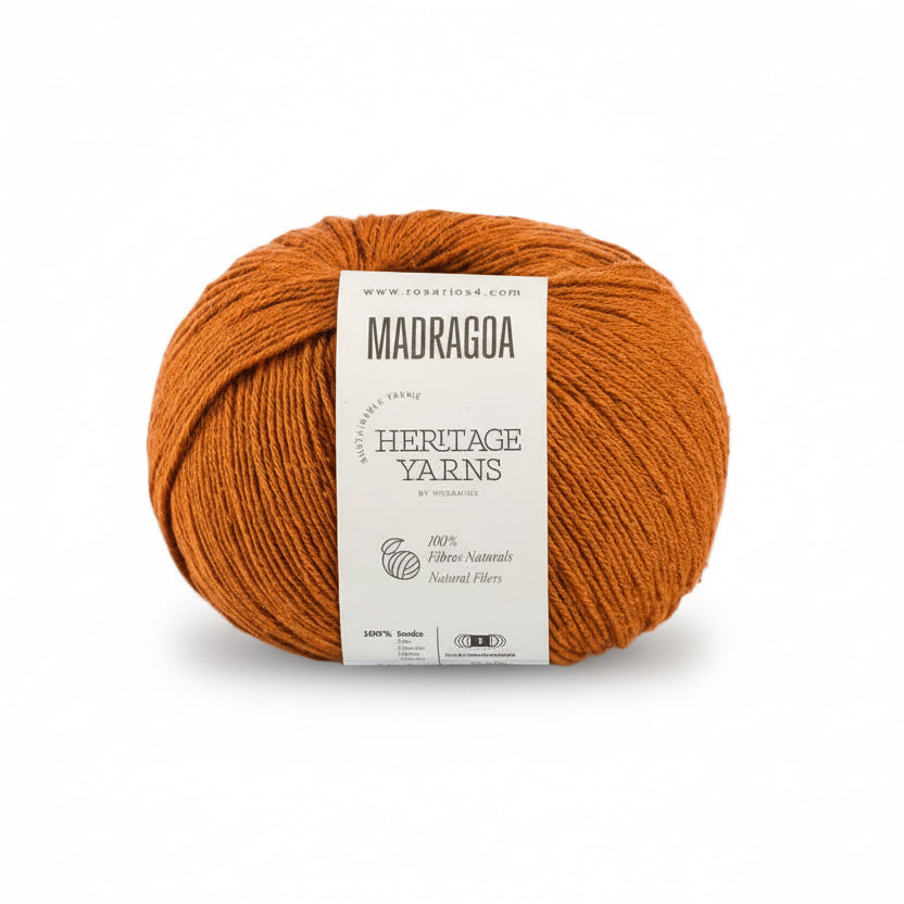 Orange skein of silk yarn with a 'Madragoa' label on a white background