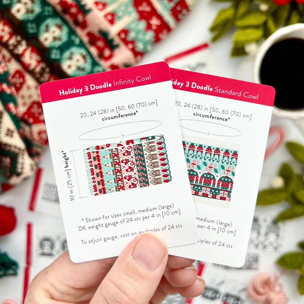 Two cards with holiday-themed designs held by a hand against a festive background.