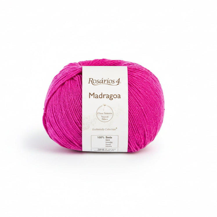 Ball of hot  pink silk yarn with a label on a white background