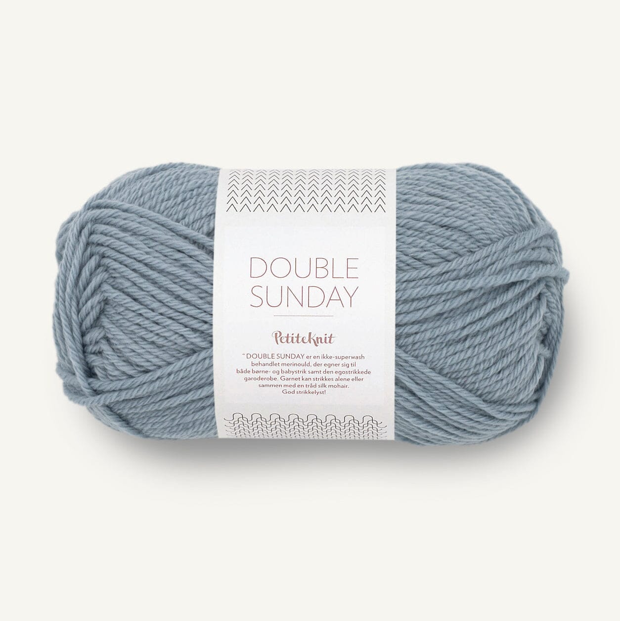 Ball of blue yarn with a label on a white background