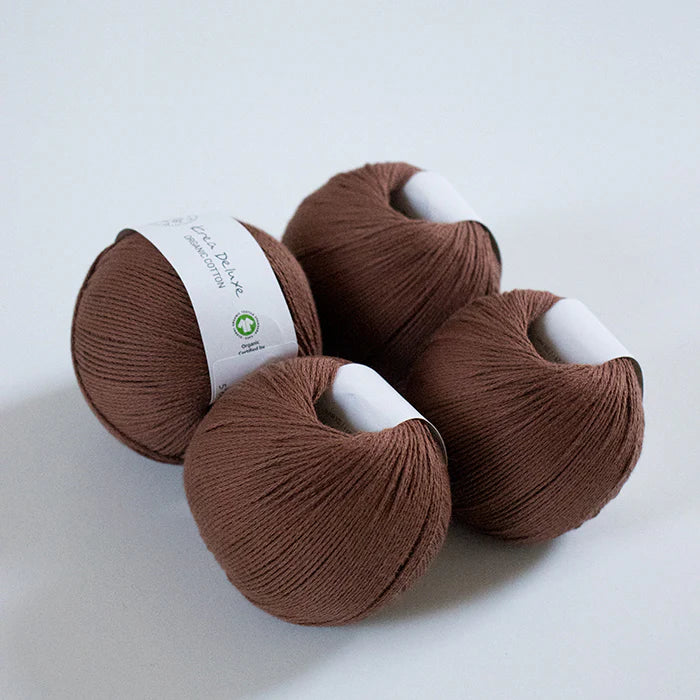 Three brown yarn balls on a white background