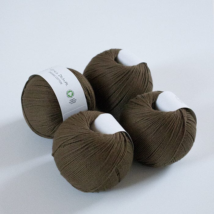 Four skeins of brown yarn with labels on a white background