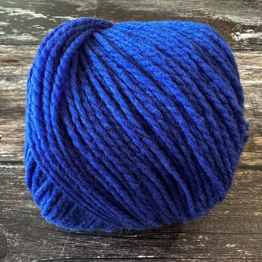 electric Blue yarn ball on a wooden surface