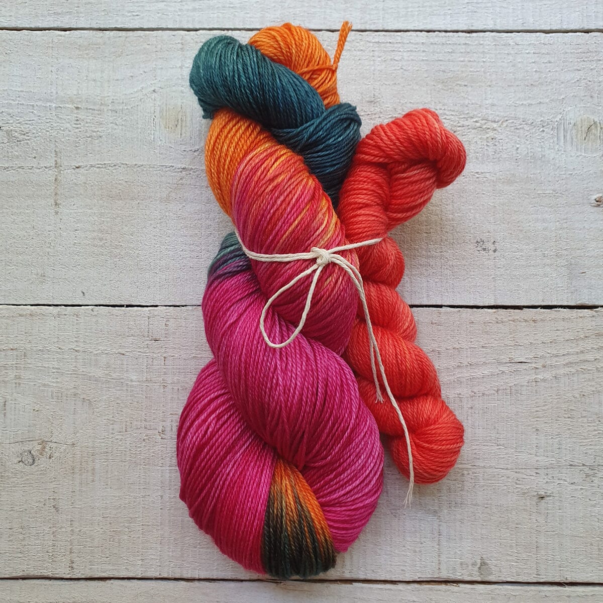 Colorful skeins of yarn on a wooden surface