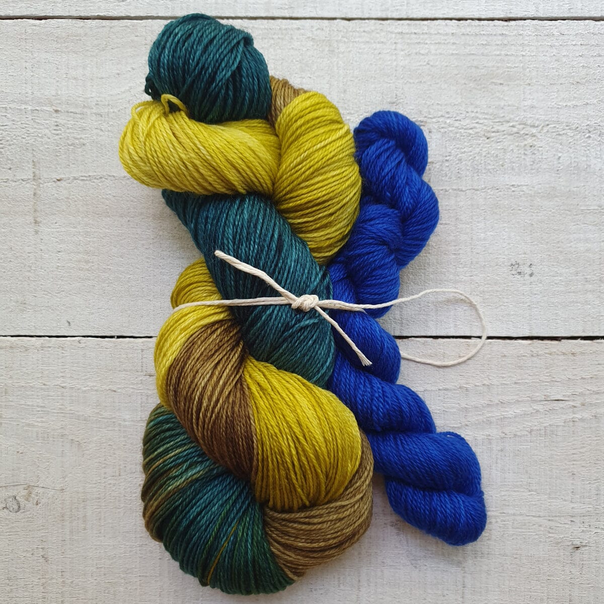 Colorful skeins of yarn on a wooden surface