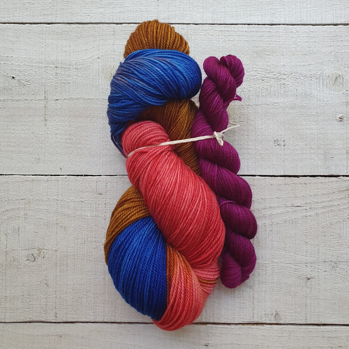 Colorful skeins of yarn on a wooden surface