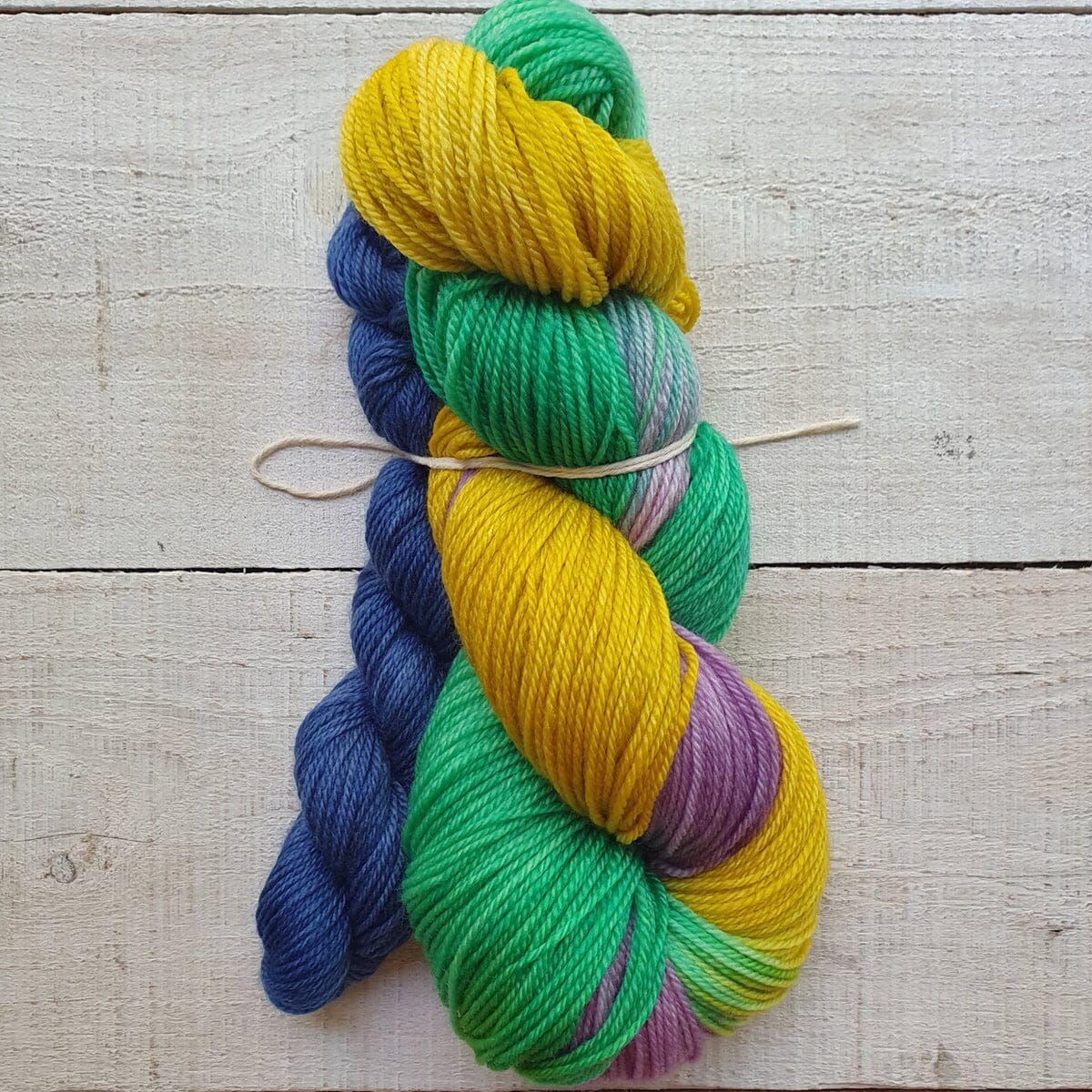 Colorful skeins of yarn on a wooden surface