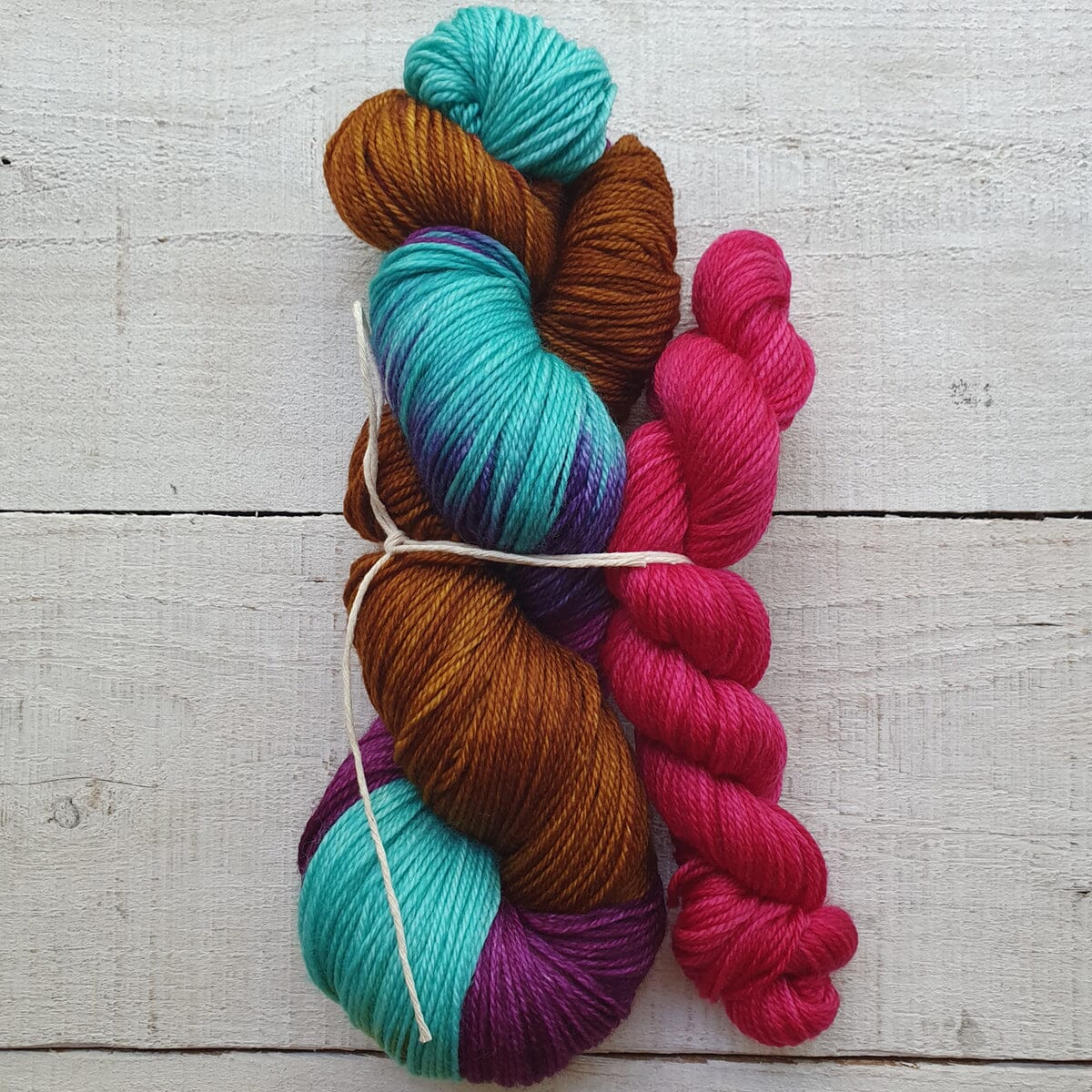 Colorful skeins of yarn on a wooden surface