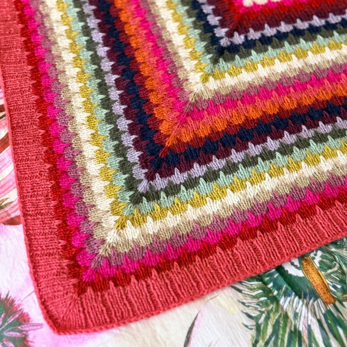 Colorful striped shawl on a stand with a blurred background