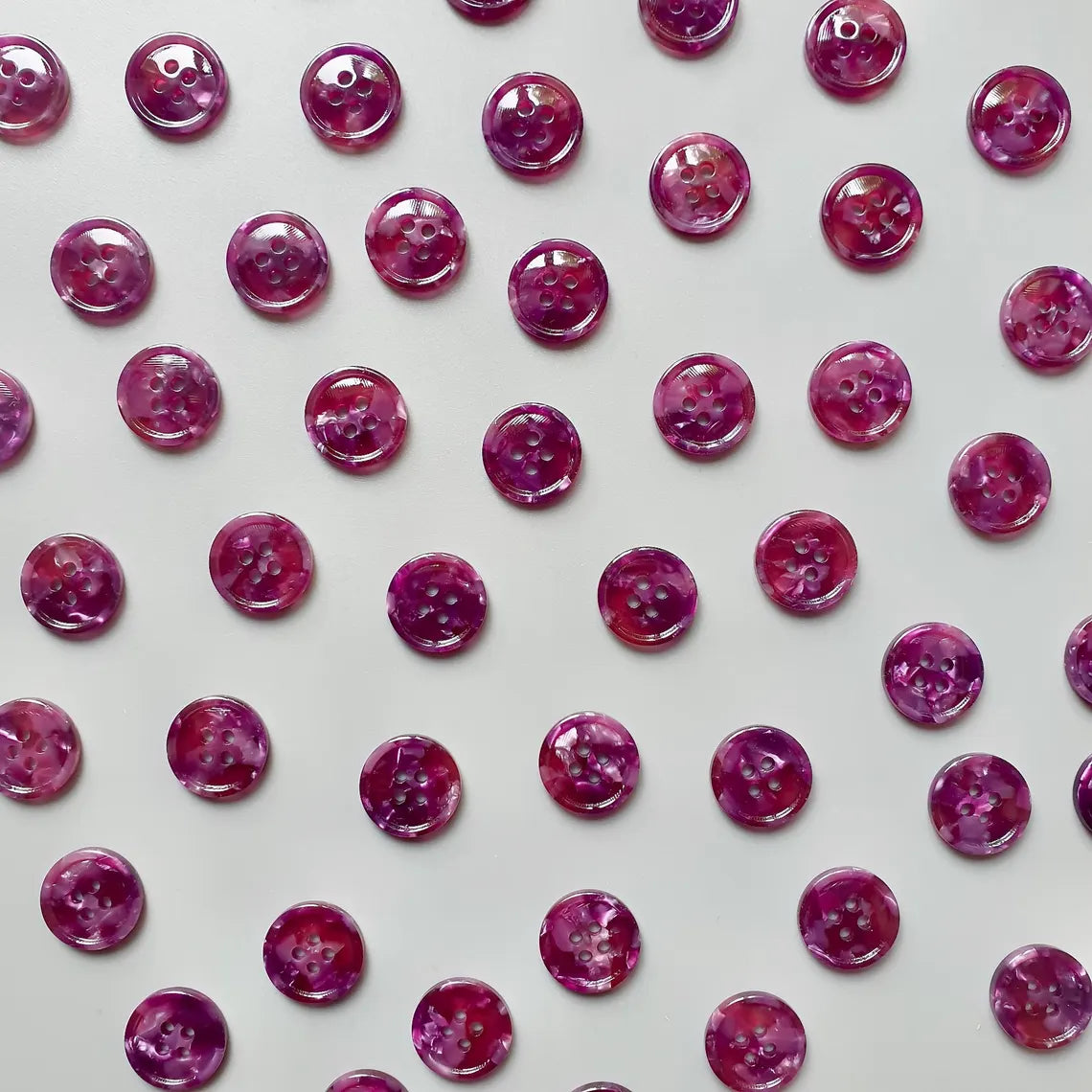 Pattern of purple buttons on a light gray background