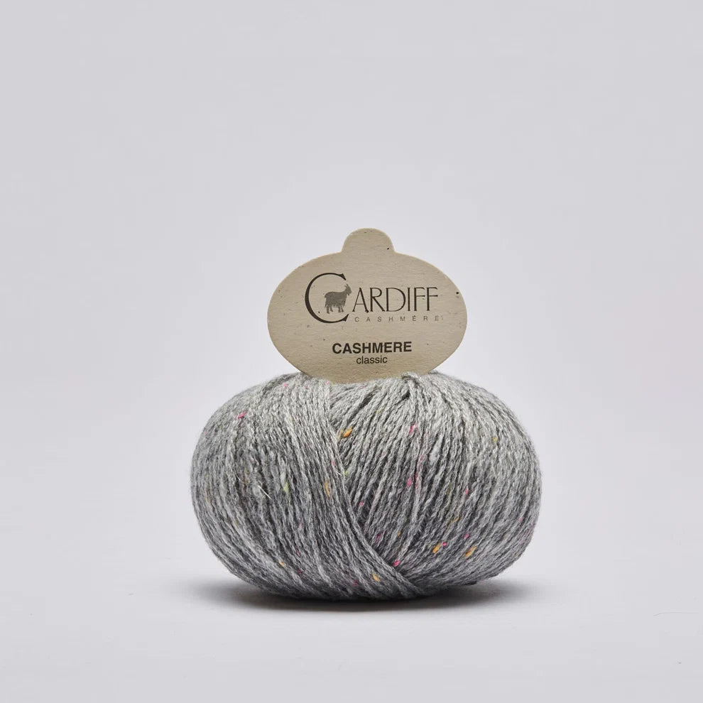 Ball of gray cashmere yarn with a Cardiff Yarns label on a light gray background