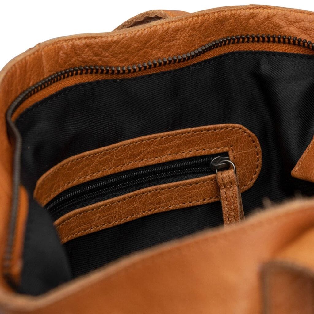 Close-up of a brown leather bag with a zipper