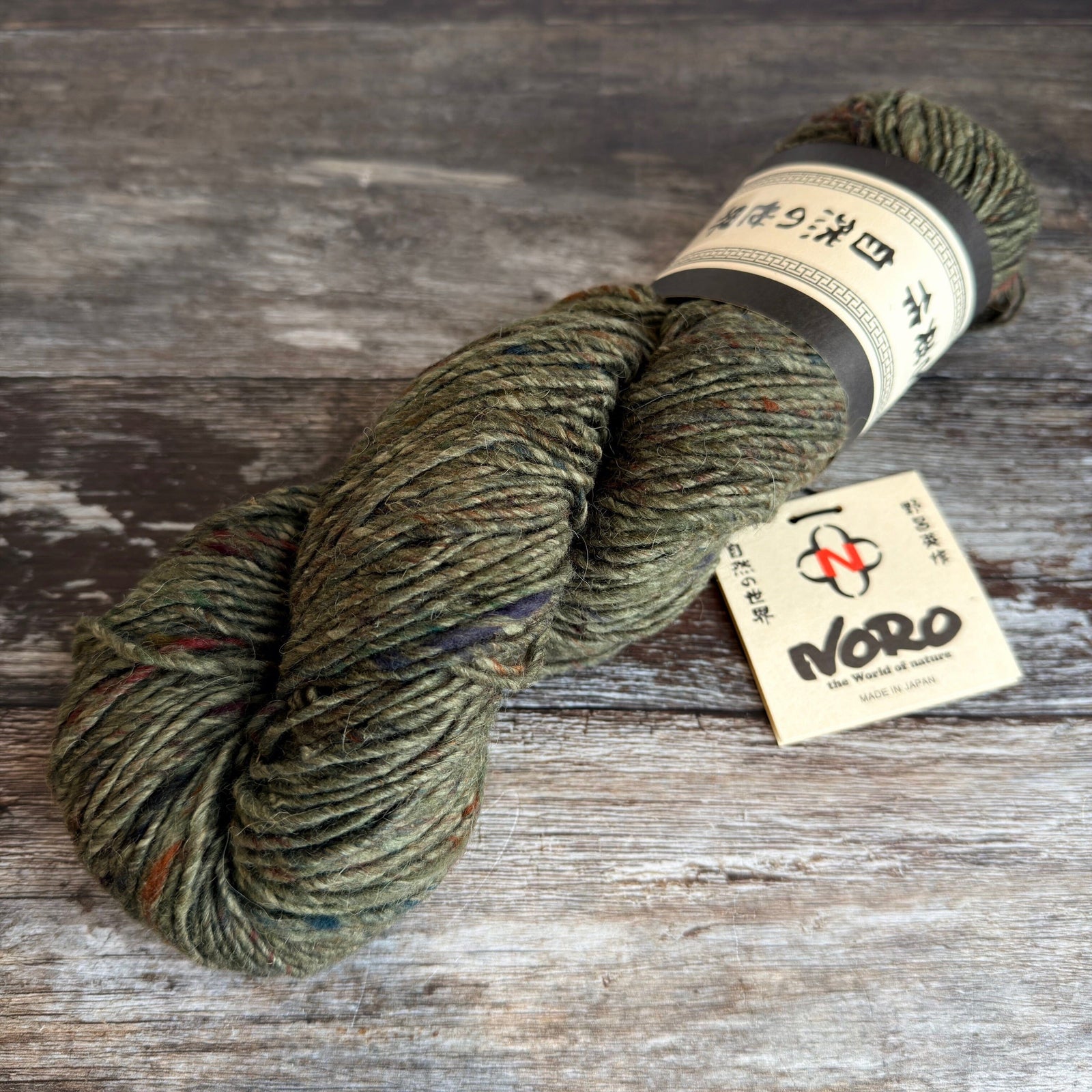  skein of green yarn with a Noro label on a wooden surface