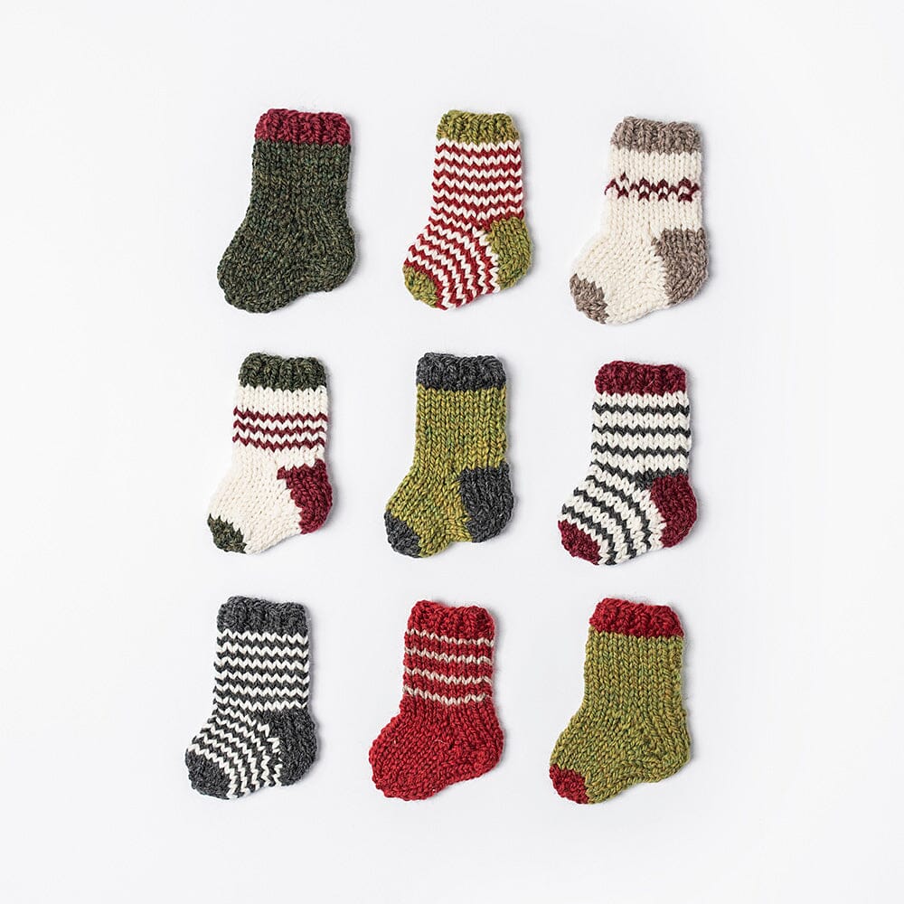 Set of small knitted socks with various patterns on a white background