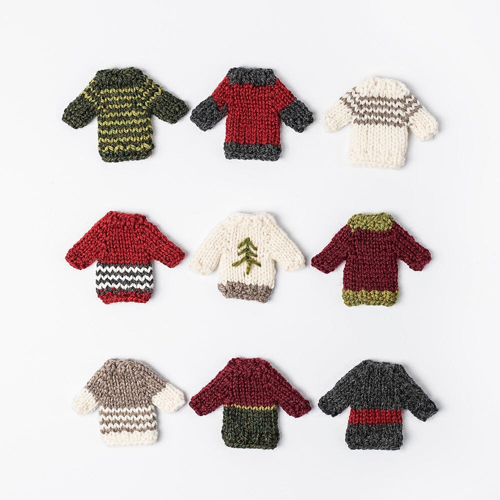 Set of small knitted sweater ornaments on a white background