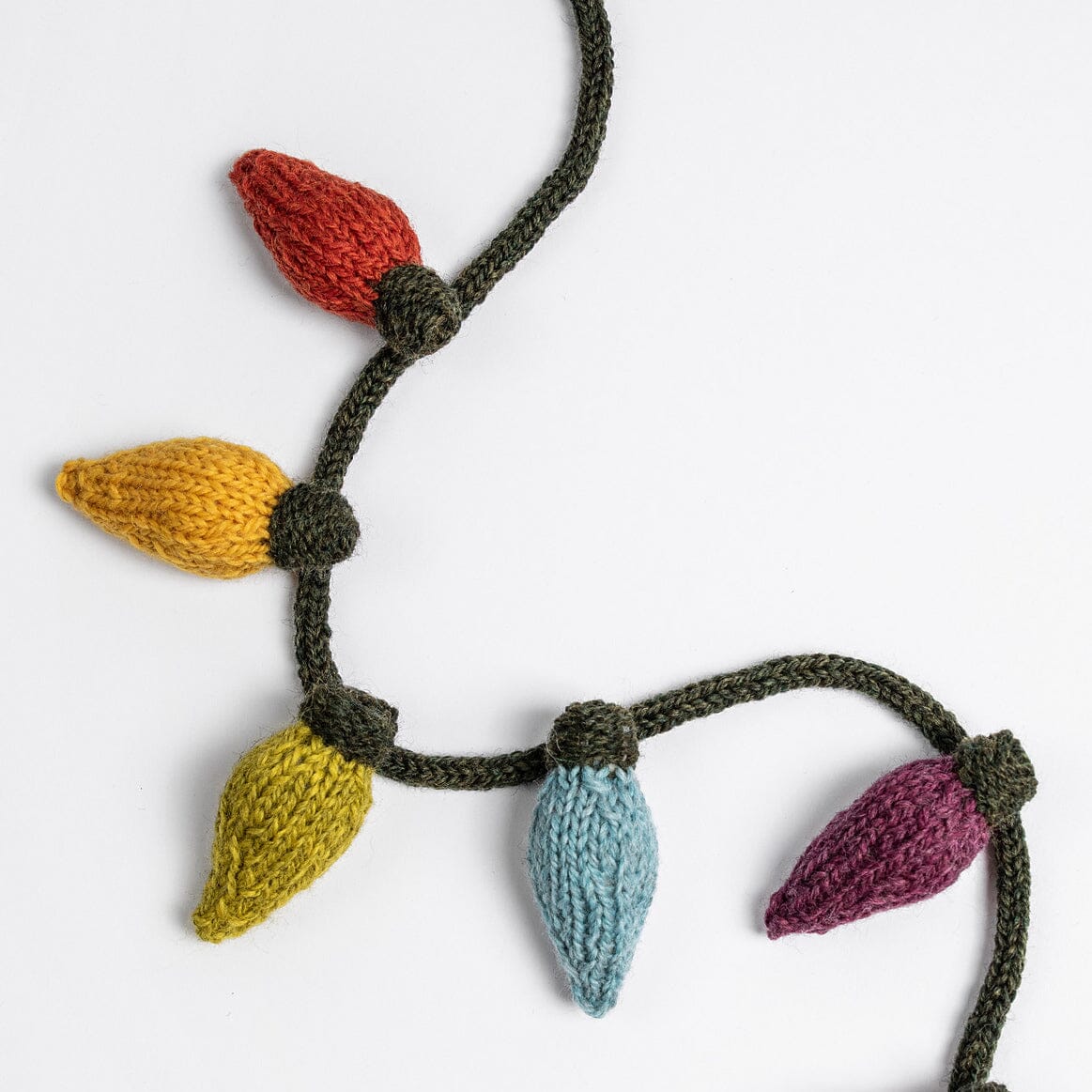 Knitted decorative garland with colourful lights on a white background