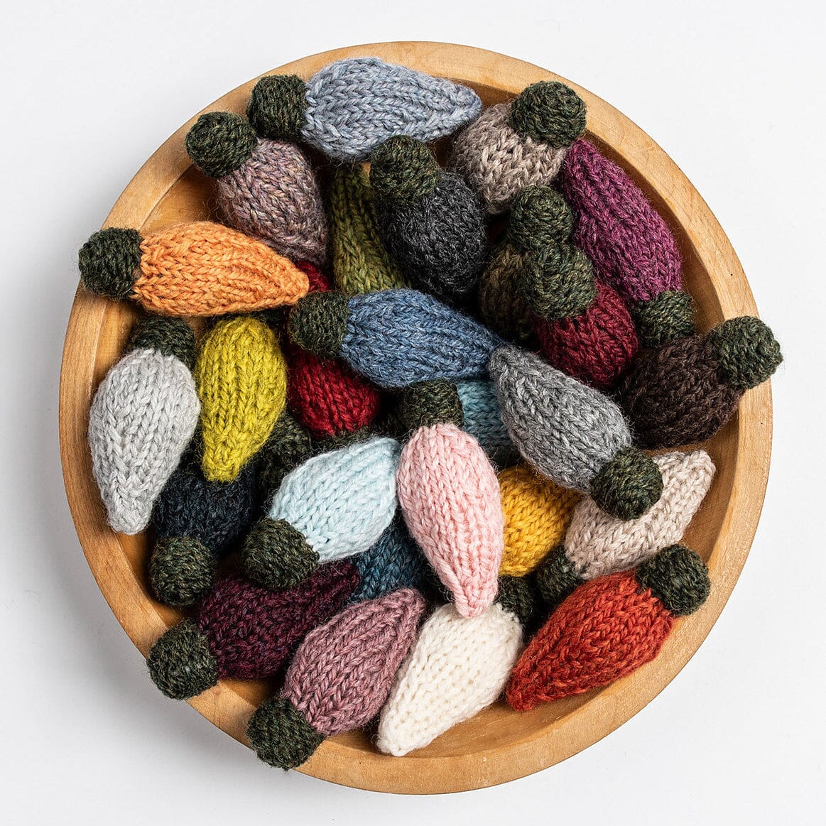 Knitted wreath with colourful bauble-shaped decorations on a white background