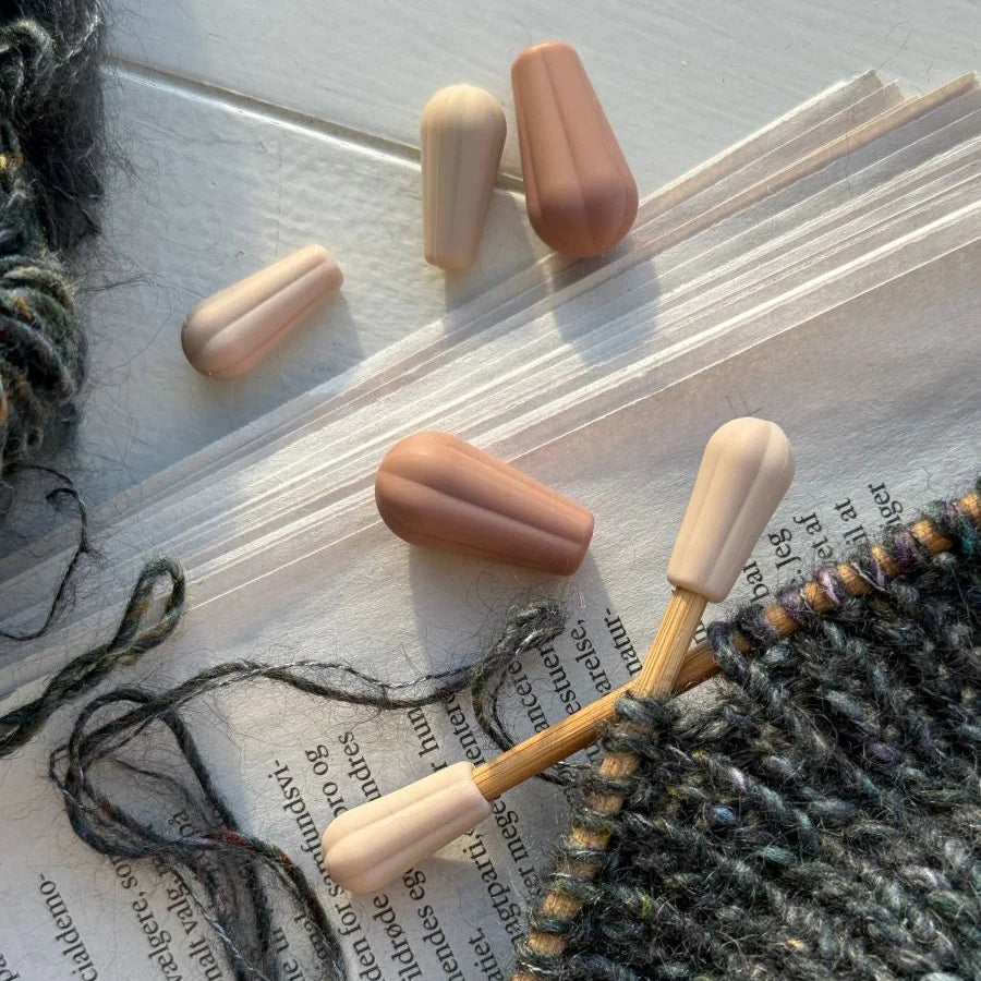 Knitting tools on an open book with yarn