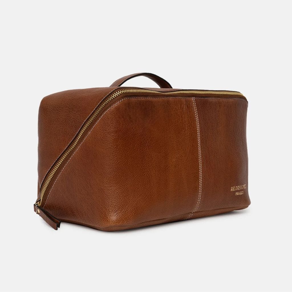 Brown leather knitting bag with gold zipper on a white background
