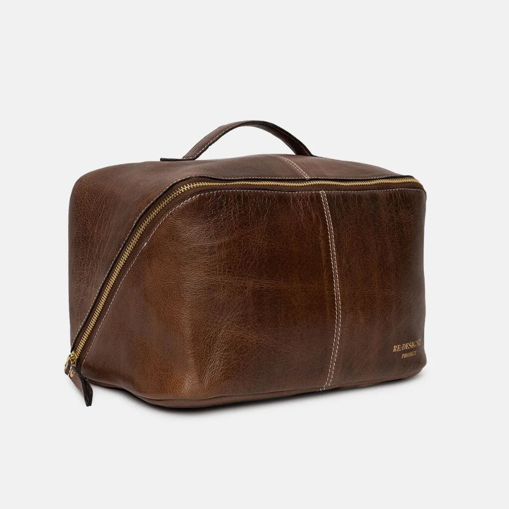 Brown leather project bag with gold zipper on a white background