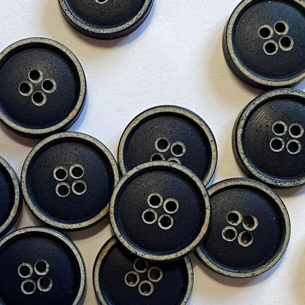 Collection of green buttons with brown edges on a white background