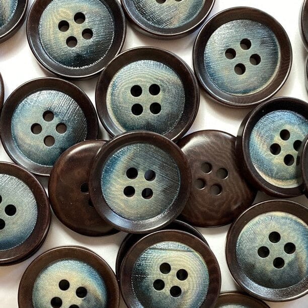 Close-up of brown and blue buttons with a textured surface.